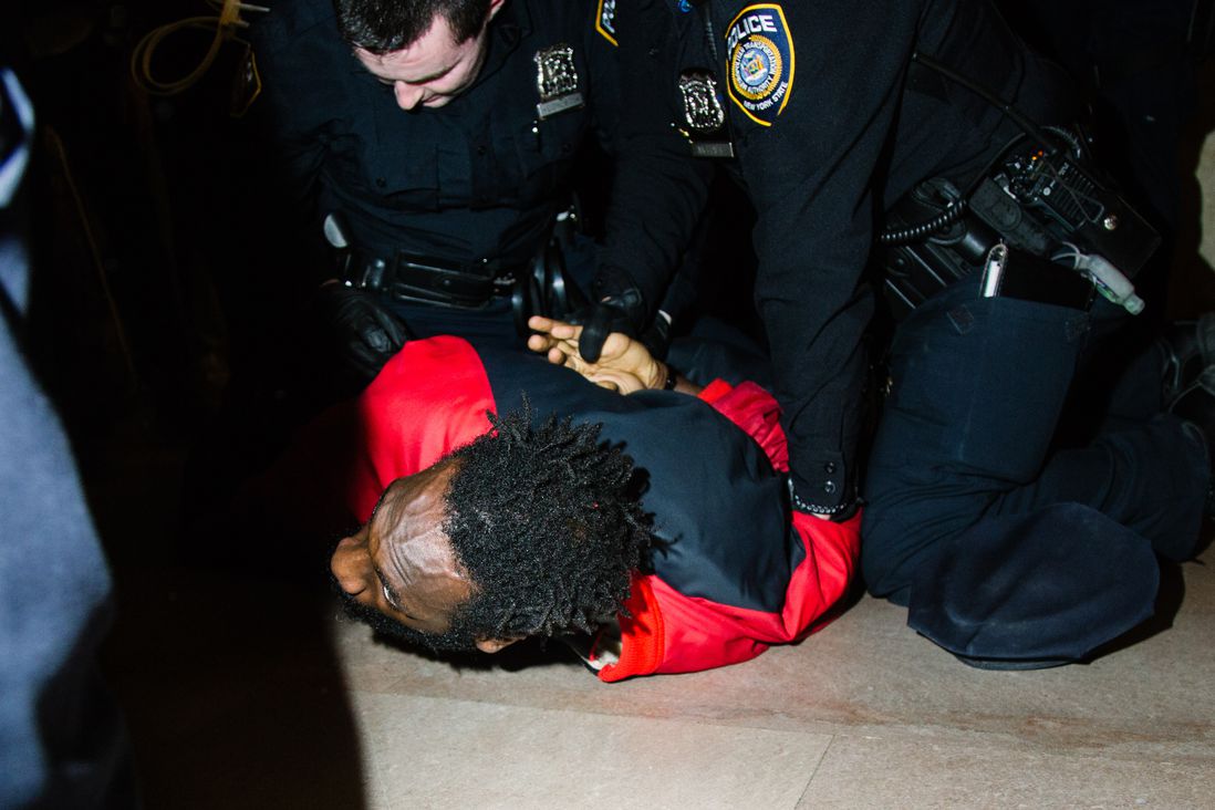 A protester is arrested in Grand Central on Friday night.